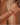 Gold bracelet on a wrist with a blurred background