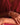 Close-up of a person wearing a silver bracelet on a red fabric background